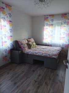 a bedroom with a bed in a room with curtains at Wehr Orchidee Apartment in Wehr