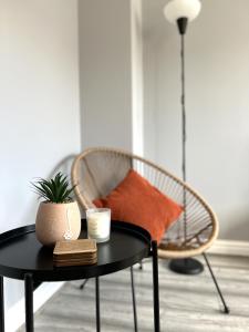 a coffee table with a plant and a chair at Franklin Suite - Reading City Centre - Free Parking - Close to Station in Reading +14 photos