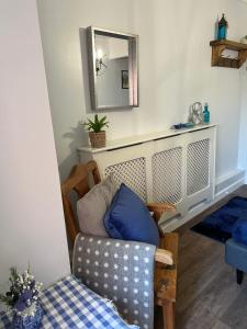 a living room with a chair and a mirror at Glastonbury Hideaway in Glastonbury