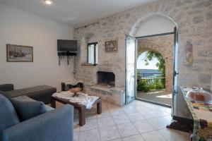 a living room with a fireplace and a glass door at Olga's House in Neo Itilo