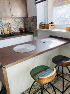 a kitchen with two stools and a counter top at Residence Park lovely apartman with private parking in Kysucké Nové Mesto