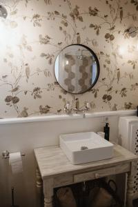uma casa de banho com um lavatório e um espelho em Historical Penthouse on Isola dei Pescatori em Someraro