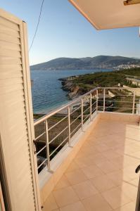 a balcony with a view of the ocean at Sunset Apartments Berdenesh Sarandë in Sarandë