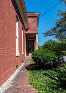 a brick building with a staircase leading to a door at Three Bedroom Apartment In Historic Nulu Property in Louisville