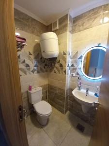 a bathroom with a toilet and a sink at Two Bedrooms for Families only Chalet Sia Lagoon Golf Porto Marina للعائلات فقط شاليه غرفتين كريستال لاجون جولف بورتو مارينا in El Alamein