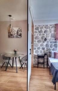 a bedroom and a dining room with a table at Casa Vita Nova in Perast
