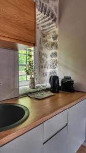a kitchen with a counter with a sink and a window at Casa Vita Nova in Perast