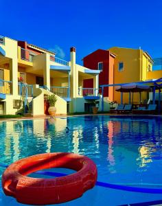 a swimming pool with a red ring in the water at Niriides in Kyparissia