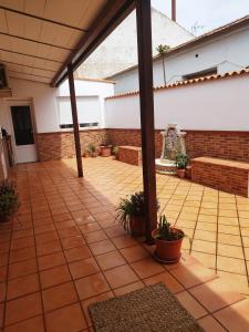 eine leere Terrasse mit Pflanzen und einer Ziegelwand in der Unterkunft Retiro del Bullaque in El Robledo