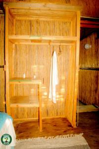 a small wooden room with a bed and a table at Mokoka Rest Camp in Nata