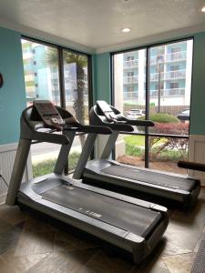 two treadmill machines in a room with a window at Shoalwater 704 in Orange Beach