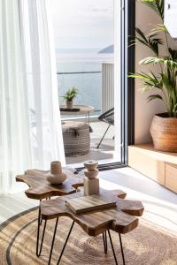 a living room with a table and a view of the ocean at Nōema Premium Stay in Neos Marmaras