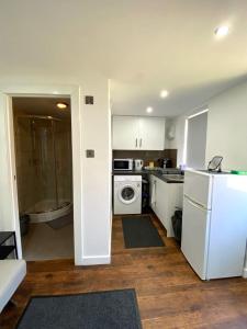 a kitchen with a white refrigerator and a stove at Kyle house in Longley