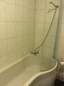 a bath tub with a shower in a bathroom at Sycamore, Moss Hagg Farm in Selby