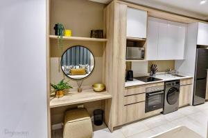 a kitchen with a sink and a mirror in it at Zimbali Lakes Boulevard Suite 134 in Sheffield Beach