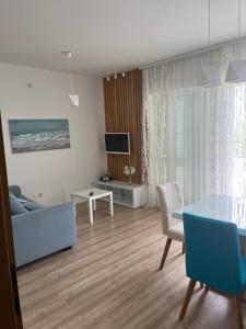 a living room with a couch and a table at Apartments Roko in Kaštela