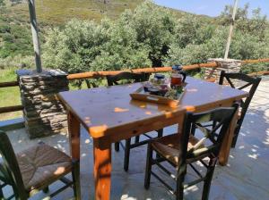 a wooden table and chairs on a patio at Ktima Kariofillis in Révmata