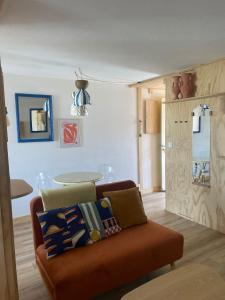 a living room with a couch and a table at Agréable Loft proche océan classé 1 étoile Refait à neuf in Biscarrosse-Plage