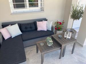 a living room with a couch and a table at Philia Apartment in Artemida