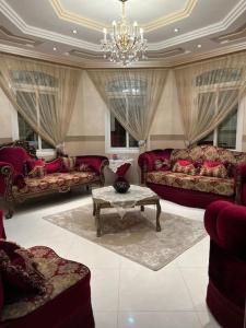 a large living room with couches and a table at The luxury Home in Abha