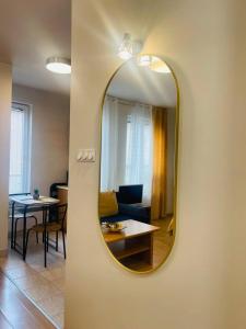 uno specchio su una parete con un soggiorno e un tavolo di CENTRAL STUDIO CLOSE TO ANDRASSY AVENUE for 4 persons a Budapest