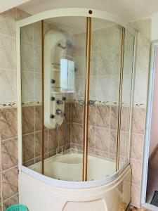 a shower with a glass enclosure in a bathroom at Florence Residence Makola in Kadawata +20 photos