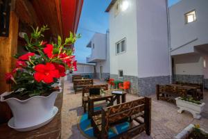 a patio with benches and flowers in a building at Vila Era Ksamil in Ksamil