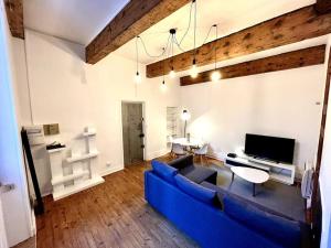 a living room with a blue couch and a tv at Grenoble Hypercentre - Appartement vieille ville - Wifi in Grenoble