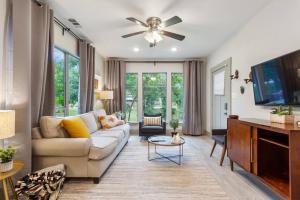 a living room with a couch and a flat screen tv at Bishop Arts Getaway! Fenced Yard, King Bed + More in Dallas