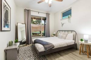 a bedroom with a bed and a mirror at Bishop Arts Getaway! Fenced Yard, King Bed + More in Dallas