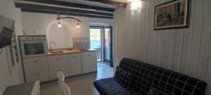 a living room with a couch and a kitchen at Apartment Desanti Valun in Valun