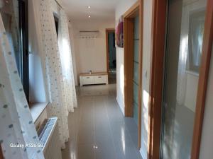 a hallway of a house with white curtains and a hallway at Lenne-Blick Ferienwohnung in Finnentrop