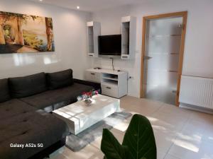 a living room with a couch and a coffee table at Lenne-Blick Ferienwohnungen-Living Apartment in Finnentrop