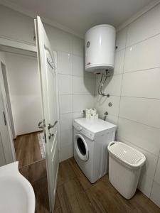 a bathroom with a washing machine and a toilet at Terzibašin Konak in Sarajevo +17 photos