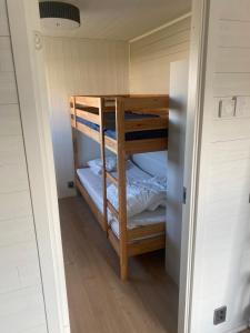 a bunk room with two bunk beds in it at Fristående hus 900m från havet in Falkenberg