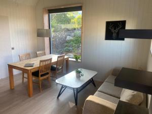 a living room with a couch and a table at Fristående hus 900m från havet in Falkenberg