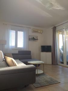 a living room with a couch and a table at Apartments Golić in Biograd na Moru