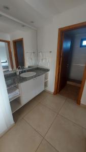 a bathroom with a counter with a sink and a mirror at La Maruca 631 in Balcarce