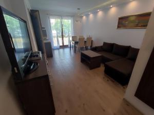 a living room with a couch and a table at Apartament Posejdon in Sztutowo