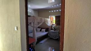 a bedroom with a canopy bed and a bedroom with a table at Villa Ste Marie in Sainte Marie