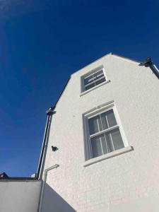 a white building with a window on top of it at A charming home in the heart of Southsea in Portsmouth
