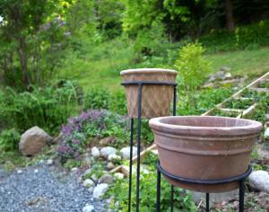 a large pot on a stand in a garden at Villa with mountain view in the Swedish High Coast in Docksta