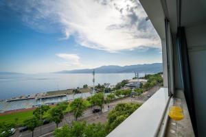 a view of the water from a window of a building at Apartman Gratitude in Rijeka