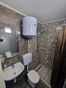 a bathroom with a toilet and a sink at Rooms Vedran in Mostar