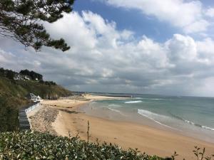a view of a beach with the ocean at Cottage le petit Tôt in Barneville-Carteret