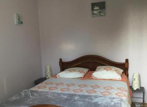 a bedroom with a bed with two pillows on it at Cottage le petit Tôt in Barneville-Carteret