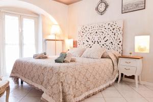 a bedroom with a large bed and a clock on the wall at CASA ROYAL sulla Reggia di Venaria in Venaria Reale