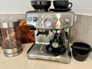 a coffee maker sitting on top of a counter at Oceanfront luxury apartment with views, king bed & private balcony in Coolum Beach