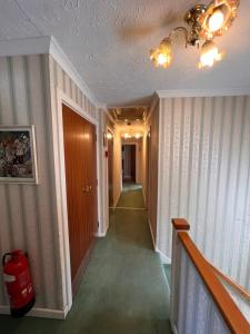 a hallway with a hallway at All Seasons Gatwick Guest House & Parking in Horley