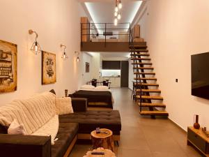 a living room with a couch and a staircase at Loft Athens -Nomad Friendly # SuperHost hub# in Athens
